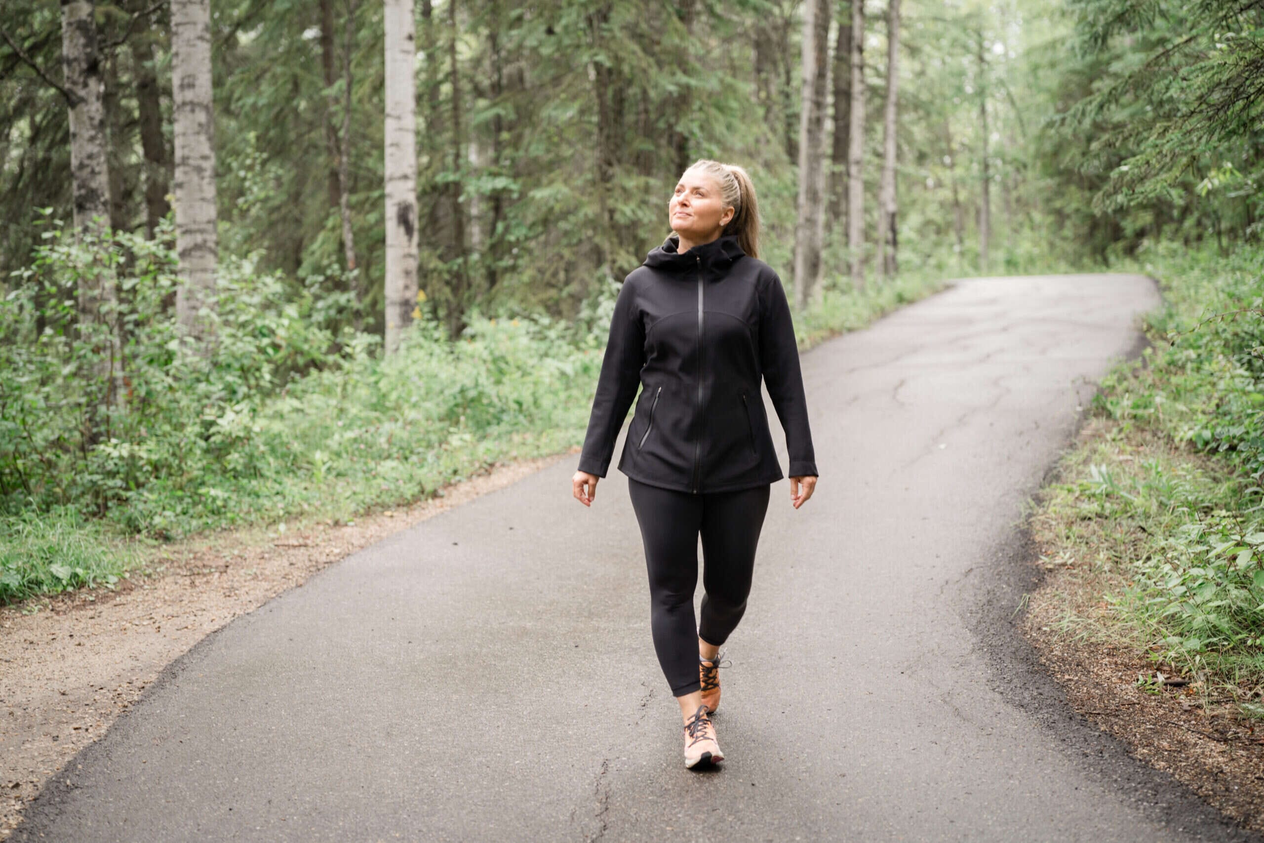 Walking through forest on a paved path