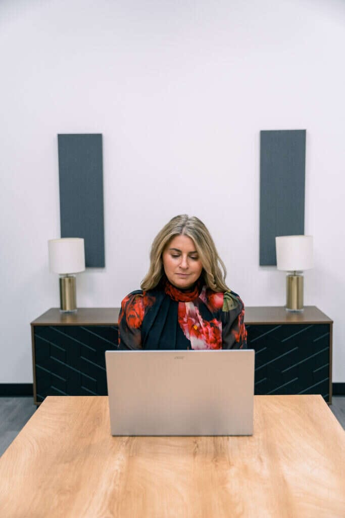Person Centered Practice founder working on her laptop