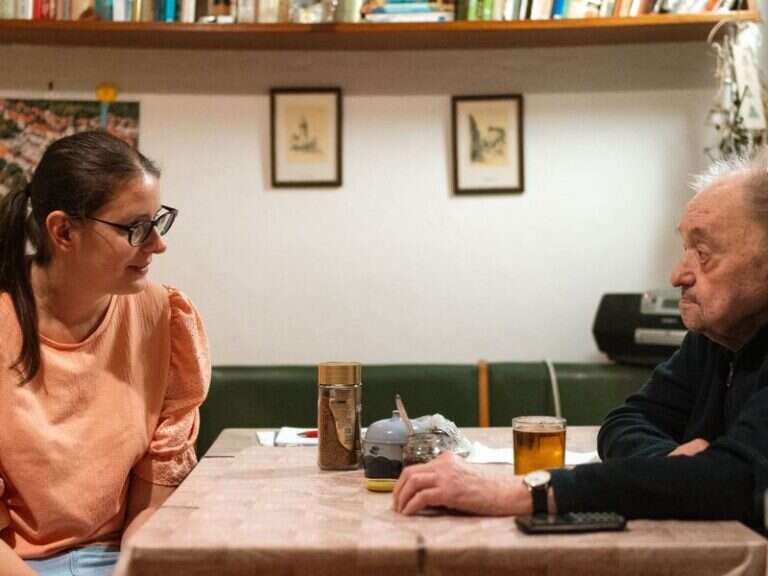 Two people in conversation across a table